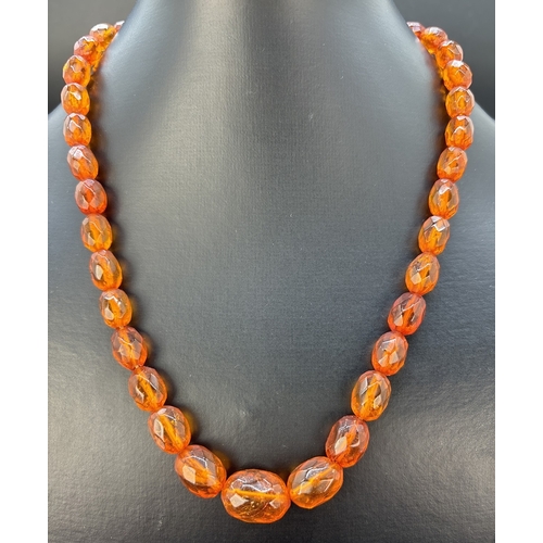 111 - A vintage 20 inch facet cut graduating amber bead necklace with push clip clasp. Total weight approx... 