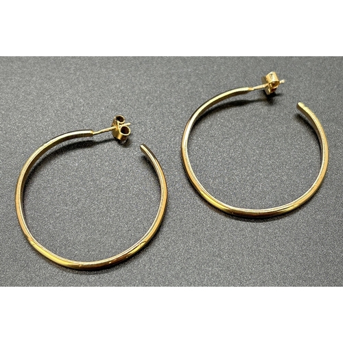 112 - A pair of large plain 9ct gold hoop earrings with posts and butterfly backs. Approx. 3.75cm diameter... 