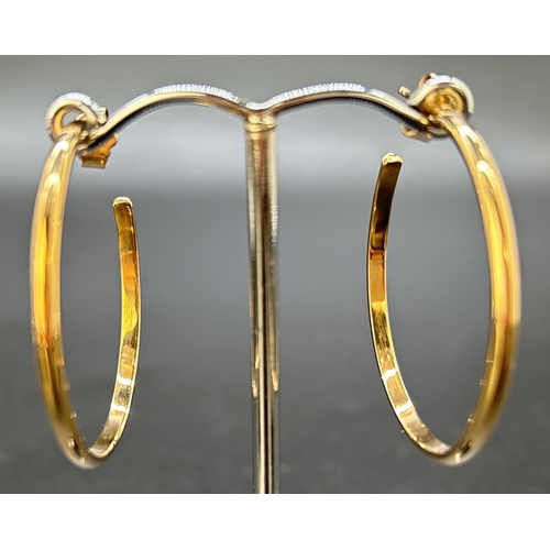 112 - A pair of large plain 9ct gold hoop earrings with posts and butterfly backs. Approx. 3.75cm diameter... 