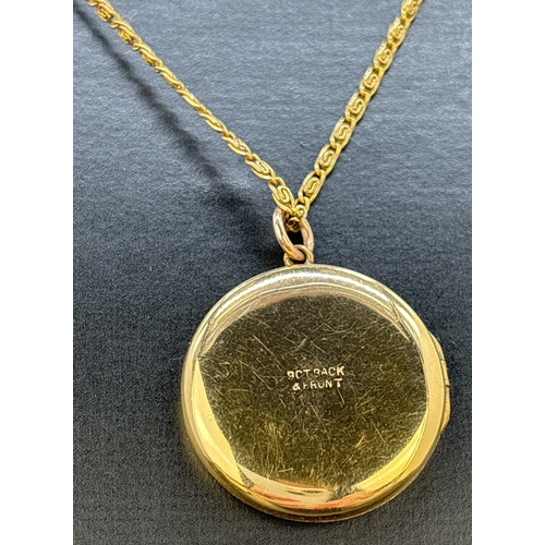 115 - A vintage circular 9ct gold front and back locket with foliate design engraving to front. On an 18