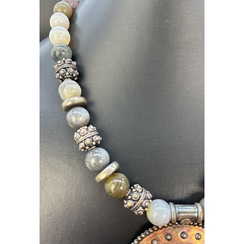 121 - A modern design 18 inch banded agate and silver bead necklace with large circular pendant and lobste... 