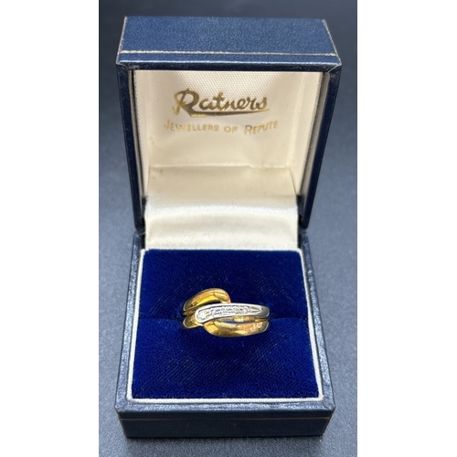 122 - An 18ct yellow and white gold crossover band style ring with 5 small illusion set diamonds. Full hal... 