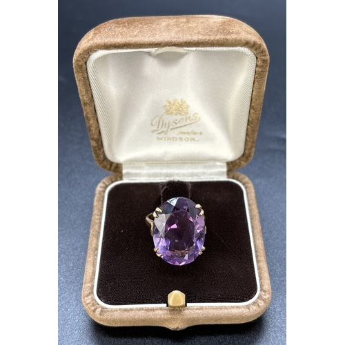 124 - A vintage unmarked yellow gold cocktail ring with large oval cut amethyst in a double pronged open w... 