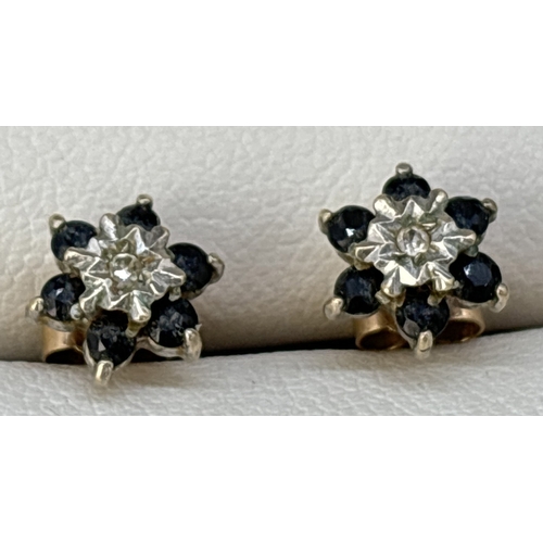 126 - A small pair of 9ct gold flower design sapphire and diamond stud earrings. Small central diamond sur... 