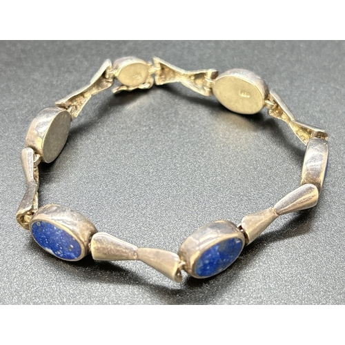 110 - A 7.5 inch modern design 850 silver bracelet set with oval panels of Lapis Lazuli. Push clasp with s... 