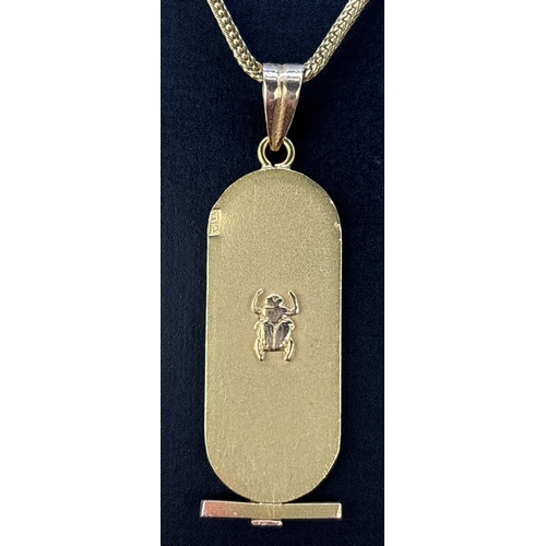 105 - An 18ct Egyptian gold hieroglyph pendant with Scarab beetle to ba Yck, o n a 24