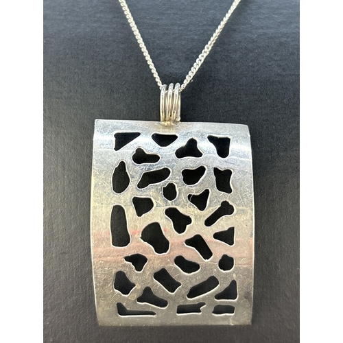 59 - A modern design silver concave rectangular pierced work pendant on am 18