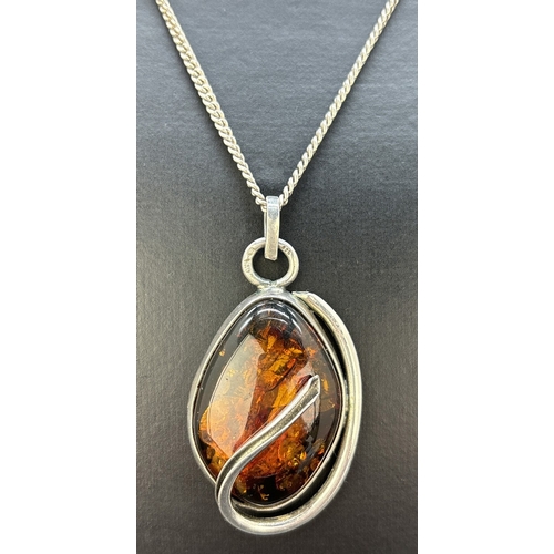 45 - A modern design silver and cognac amber set pendant on a 28 inch curb chain necklace. Silver marks o... 