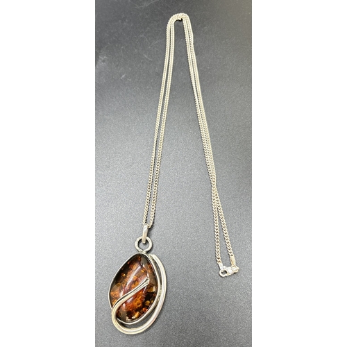 45 - A modern design silver and cognac amber set pendant on a 28 inch curb chain necklace. Silver marks o... 