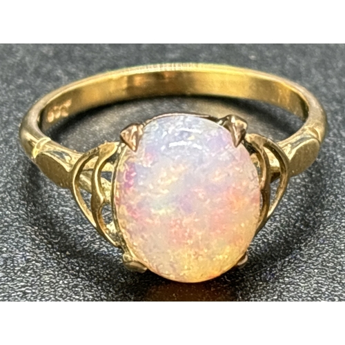 34 - A vintage 9ct gold opal cabochon dress ring. Scallop detail to shoulder with plain shank. Gold mark ... 