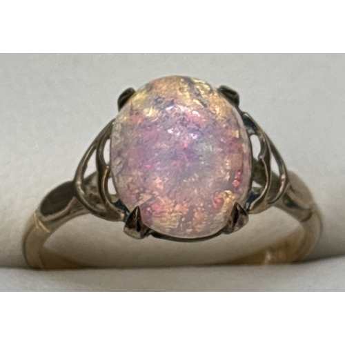 34 - A vintage 9ct gold opal cabochon dress ring. Scallop detail to shoulder with plain shank. Gold mark ... 