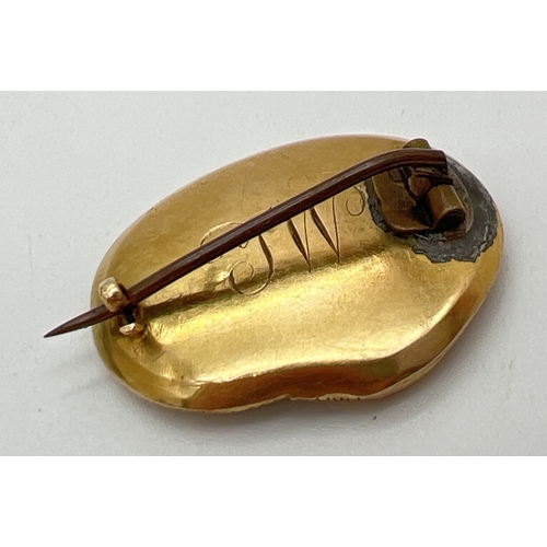 1046 - A Georgian gold Ouroboros mourning brooch with glazed central panel enclosing a lock of plaited hair... 