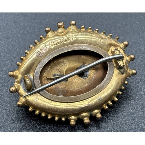 1045 - A Victorian 9ct gold oval shaped mourning brooch with scroll and beaded decoration. Panel to back of... 