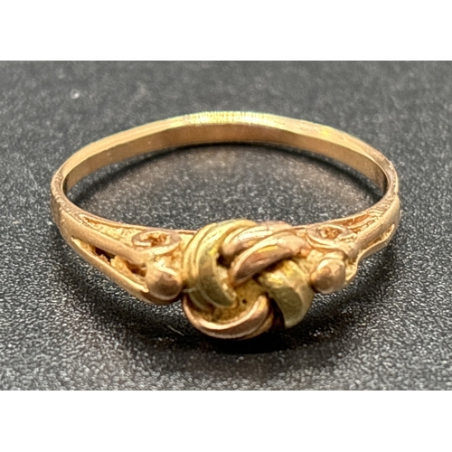 1049 - A 14ct gold lover's knot ring in yellow and rose gold with pierced work shoulders. Austrian gold mar... 