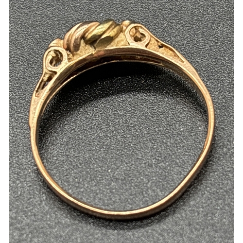 1049 - A 14ct gold lover's knot ring in yellow and rose gold with pierced work shoulders. Austrian gold mar... 