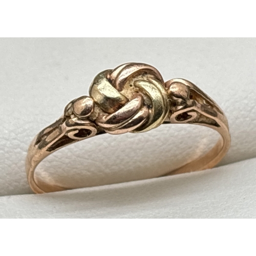 1049 - A 14ct gold lover's knot ring in yellow and rose gold with pierced work shoulders. Austrian gold mar... 