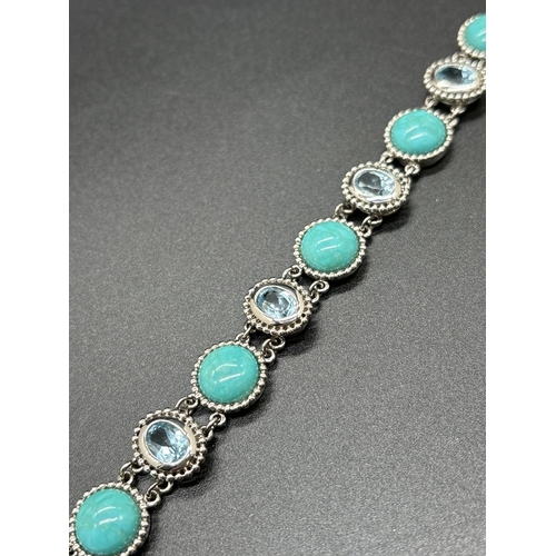 1067 - A silver bracelet set with round blue turquoise cabochons and bezel set oval cut blue topaz stones. ... 