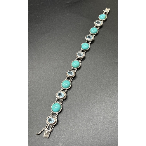 1067 - A silver bracelet set with round blue turquoise cabochons and bezel set oval cut blue topaz stones. ... 