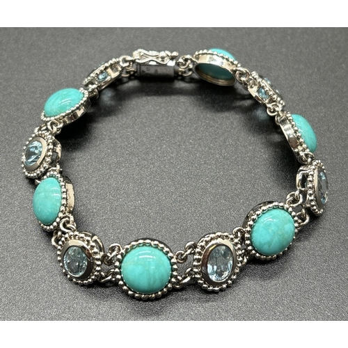 1067 - A silver bracelet set with round blue turquoise cabochons and bezel set oval cut blue topaz stones. ... 