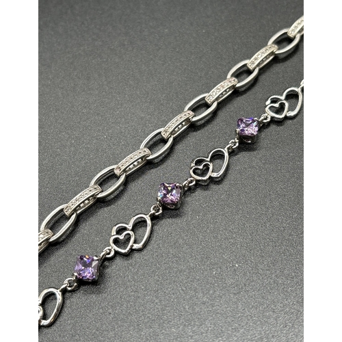 1070 - 2 silver bracelets. A double heart link bracelet with alternating purple crystals and a belcher chai... 