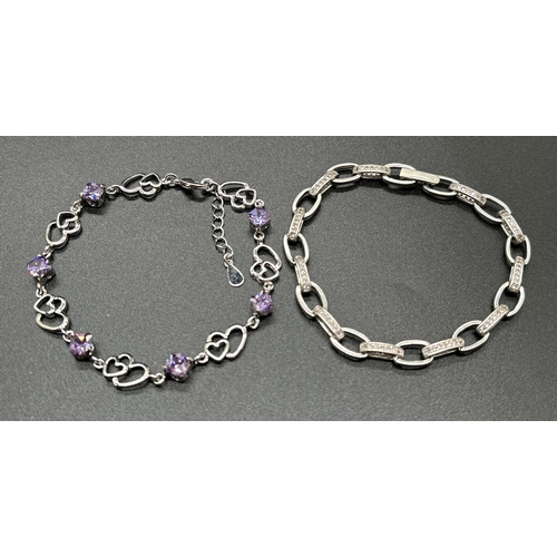 1070 - 2 silver bracelets. A double heart link bracelet with alternating purple crystals and a belcher chai... 