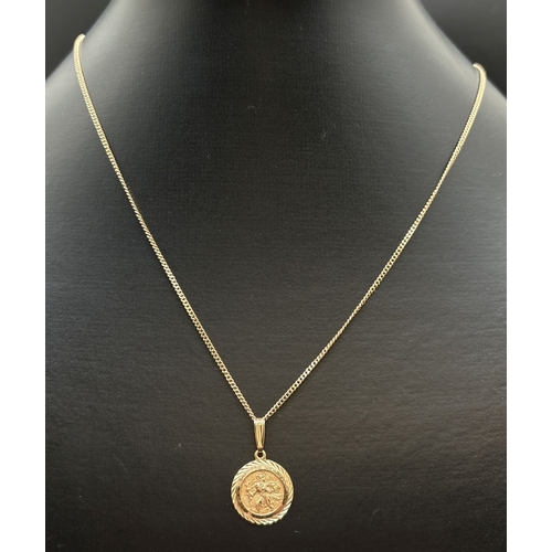 1073 - A small 9ct gold circular St. Christopher pendant on a 16 inch curb chain with spring ring clasp. Go... 