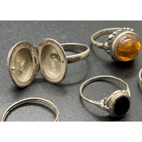 1077 - 5 silver stone set rings. To include amber cabochon with floral detail to mount & shoulders, an onyx... 