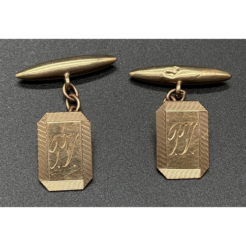 1086 - A pair of vintage 9ct gold Squared octagonal cuff links with engine turned decoration and engraved i... 