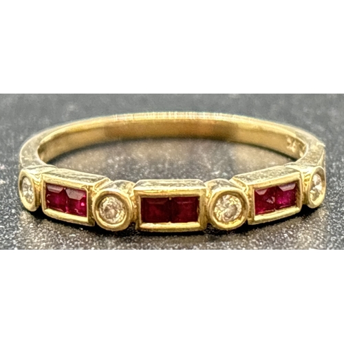 1089 - A 9ct gold ruby and diamond half eternity style ring. Bezel set with 6 square cut rubies and 4 round... 