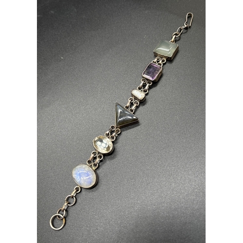 1090 - A modern design silver bracelet set with different cut semi precious stones. Stones include moonston... 