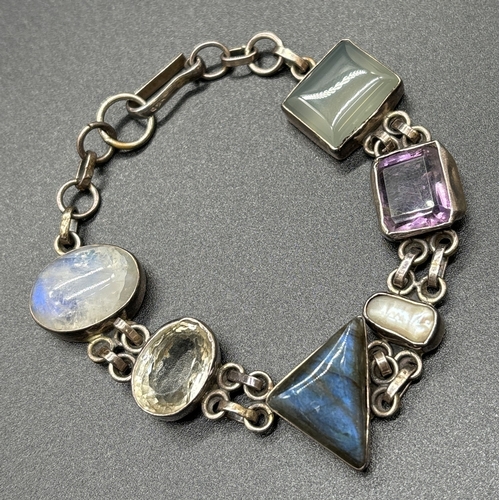 1090 - A modern design silver bracelet set with different cut semi precious stones. Stones include moonston... 