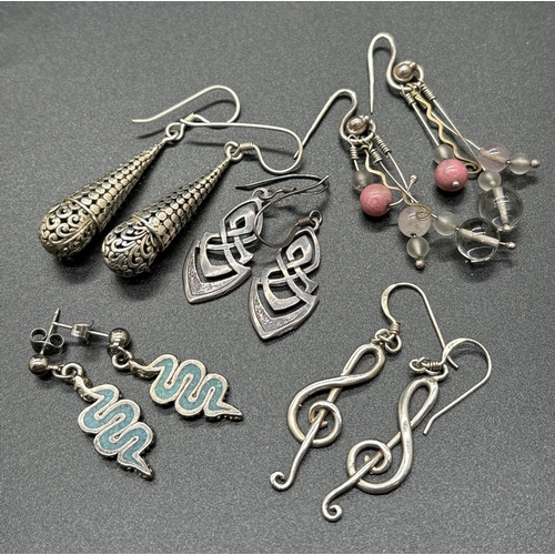 1096 - 5 pairs of silver and white metal drop style earrings. To include turquoise set serpents, musical tr... 