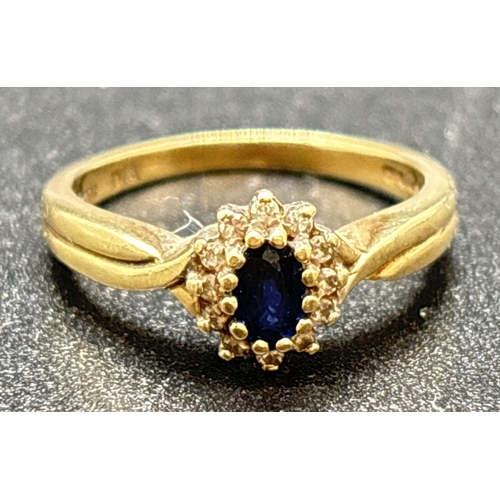 1100 - A 9ct gold, sapphire and diamond cluster ring with twist design shoulders and plain shank. Central o... 