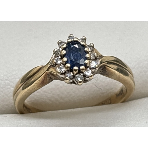 1100 - A 9ct gold, sapphire and diamond cluster ring with twist design shoulders and plain shank. Central o... 