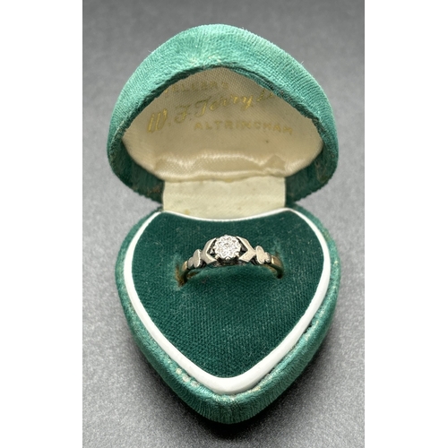 1101 - A 9ct gold diamond solitaire ring with platinum mount and shoulders. Hallmarked inside band. Ring si... 