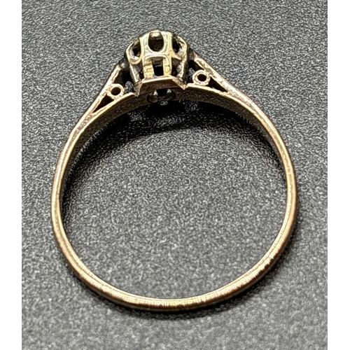 1104 - A 9ct gold diamond solitaire ring with illusion engraved design to shoulders. Stamped 9ct inside ban... 