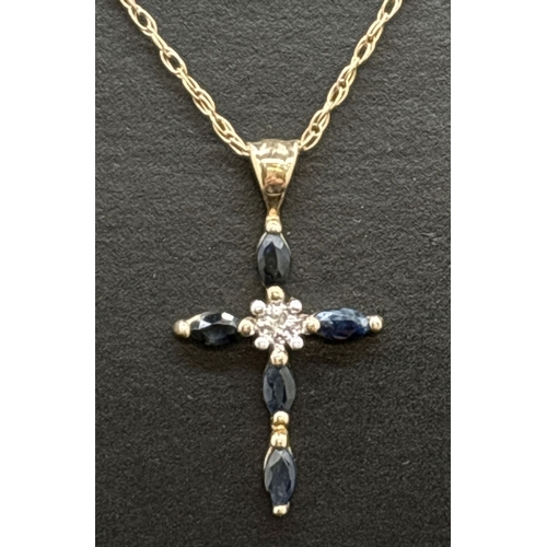 1123 - A 9ct gold, sapphire and diamond set cross pendant on an 18