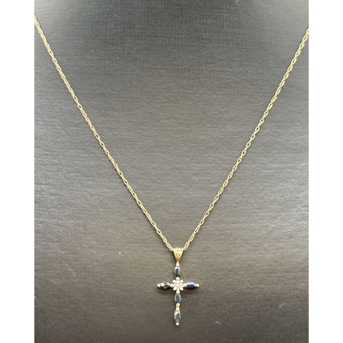 1123 - A 9ct gold, sapphire and diamond set cross pendant on an 18