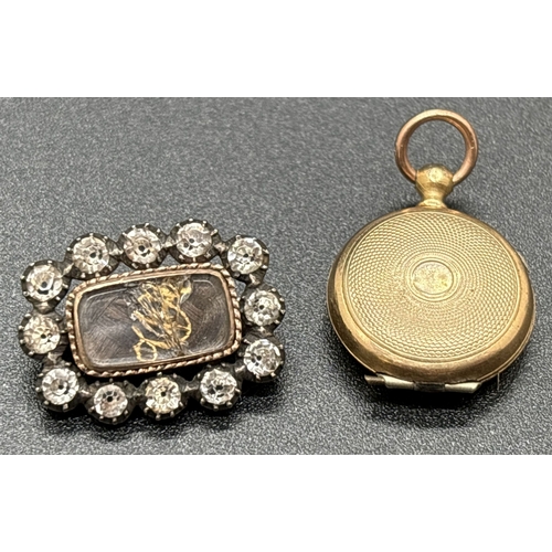 1125 - 2 small Victorian jewellery items. A small rose gold backed mourning brooch with plaited hair behind... 