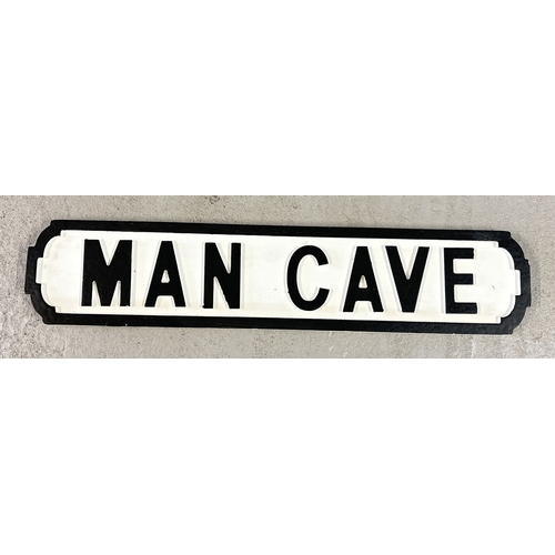 1381 - A modern painted wood 'Man Cave' sign, in the style of an old street sign. Approx. 64cm long.