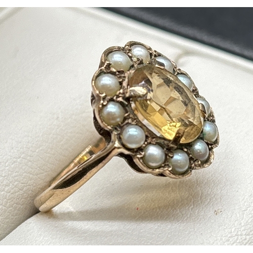 1133 - A vintage 9ct gold citrine and seed pearl dress ring with pierced shoulders and plain shank. Central... 