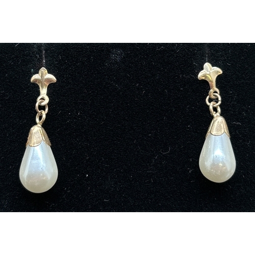 1134 - 3 pairs of gold earrings. A pair of pearl teardrops, a pair of pearl studs and s pair of clear stone... 