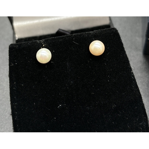 1134 - 3 pairs of gold earrings. A pair of pearl teardrops, a pair of pearl studs and s pair of clear stone... 