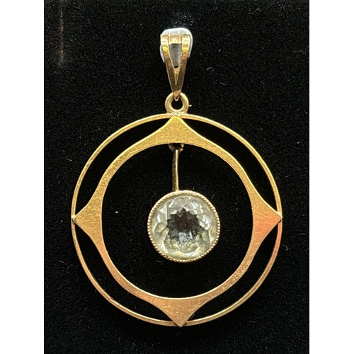 1136 - A 9ct gold Art Nouveau circular shaped pendant with suspended milgrain set round cut aquamarine. Gol... 