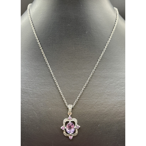 1137 - A silver Victorian inspired drop pendant necklace. Pendant set with a central oval cut amethyst and ... 