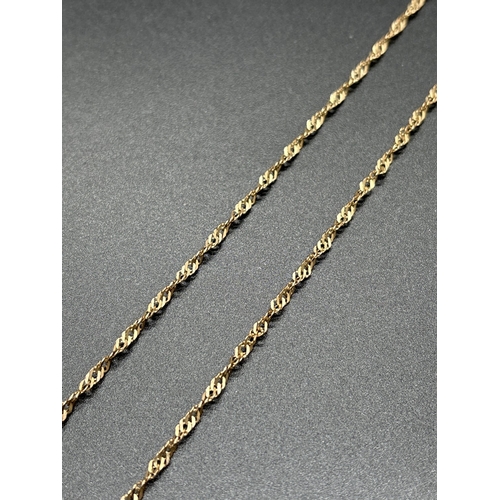 1139 - A 9ct gold 24 inch Singapore style chain with spring ring clasp. Gold marks to fixings. Weight appro... 