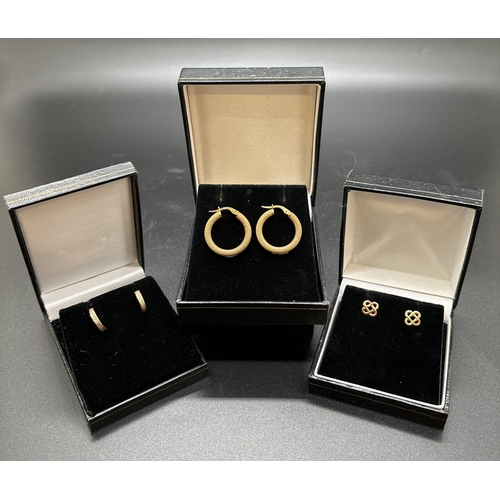 1142 - 3 pairs of 9ct gold earrings. A pair of diamond patterned hoops, a pair of Celtic knot stud earrings... 