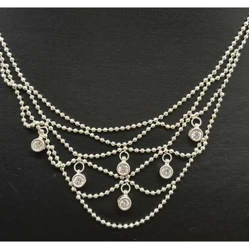 1144 - 2 items of silver jewellery. A 16 inch silver ball bead collar style necklace with suspended clear s... 