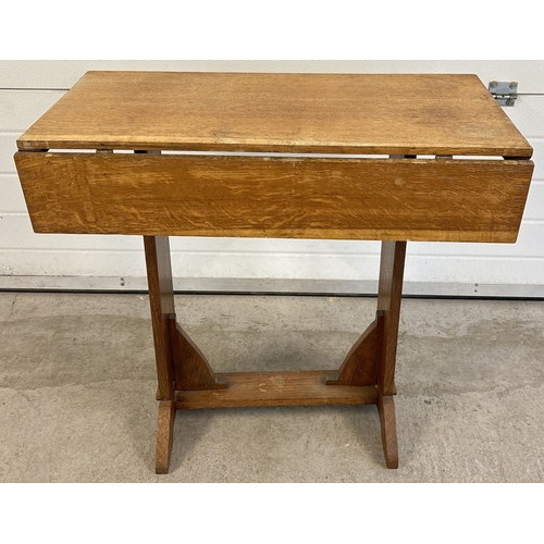 1437 - An Arts & Crafts light oak swivel top drop leaf occasional table with wedge feet. Approx. 75.5cm tal... 