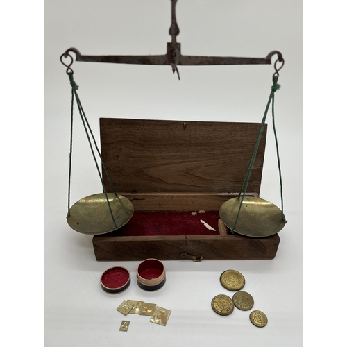 1387 - A set of early 20th century travelling apothecary scales in wooden case, with brass pans and steel b... 